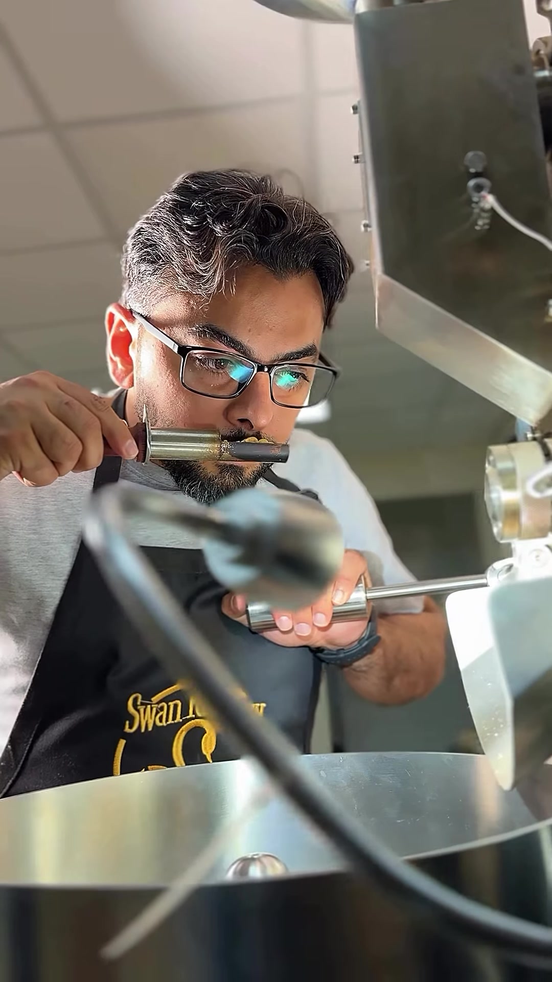 Ahmed Al-Hayki checking a roast sample at Swan Roastery